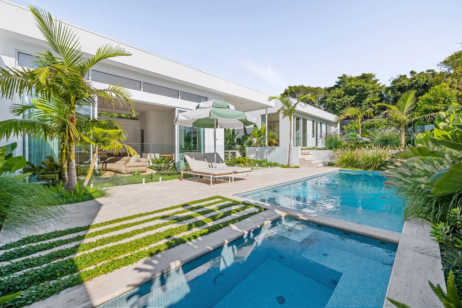 Glasshouse, Mount Eliza. Pool and planting through the palms.